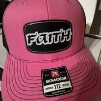 Pink baseball cap with FAITH logo patch and stitched bill, showing brand tag