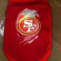 Red pet shirt with San Francisco 49ers logo featuring gold and red circular emblem with scratched design effect