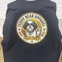Black sweatshirt with Teddy Gear Apparel logo featuring a bear head in circular gold badge design