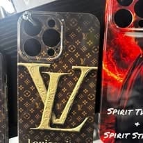 Luxury smartphone case with LV monogram pattern and gold LV logo on black and gold background