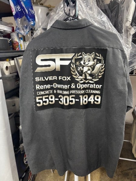 Dark gray work shirt with Silver Fox logo and text advertising concrete cleaning and pressure washing services with phone number